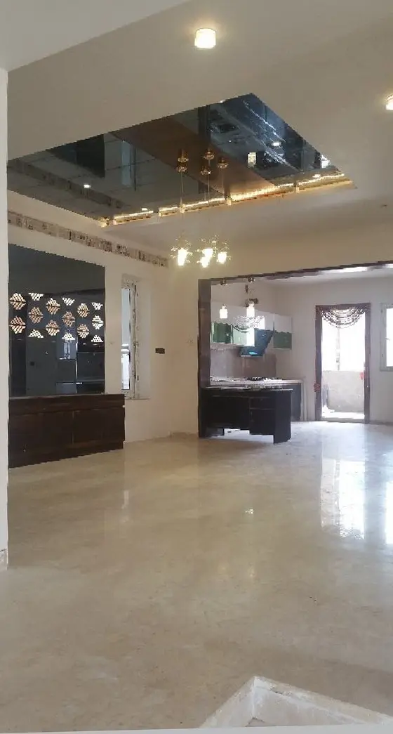 Living area with a glossy marble floor and a mirrored ceiling feature
