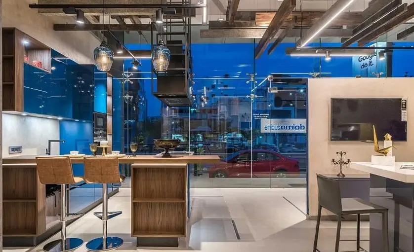 Blue display kitchen with a timber breakfast bar and bar stools
