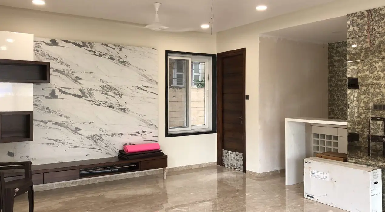 Bedroom with a marble feature wall and a slim wall-hung TV unit