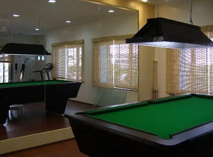 Games room with a billiards table and a gym beyond
