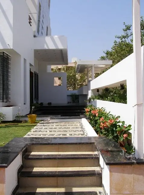 Entrance steps with stone treads, flanked by planters