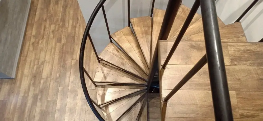 Spiral staircase in black steel with timber treads