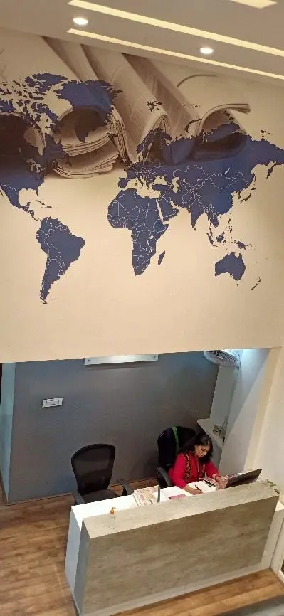 Reception desk beneath a world map mural