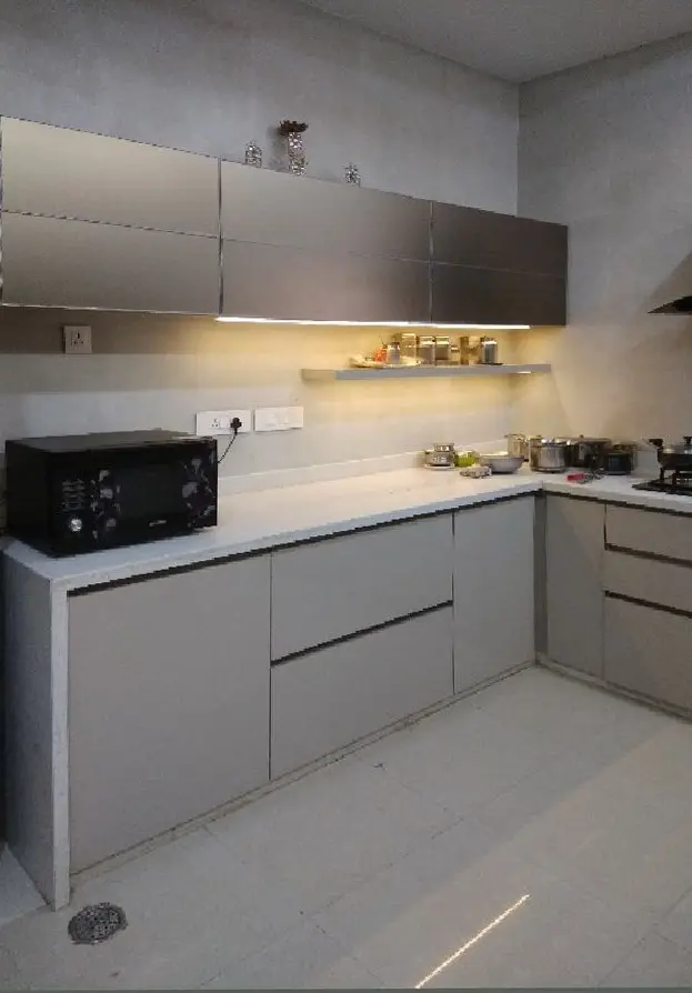 L-shaped kitchen in grey with under-cabinet lighting