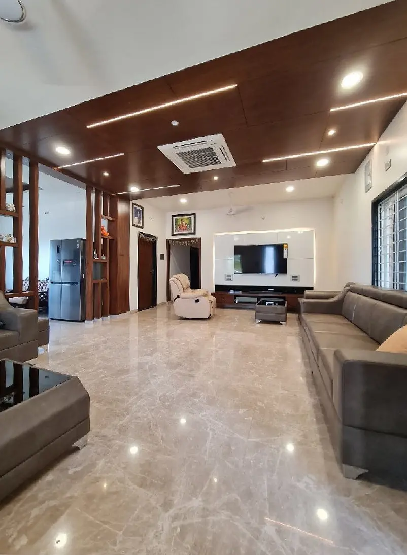 Long living and dining room with a timber ceiling band and a polished marble floor
