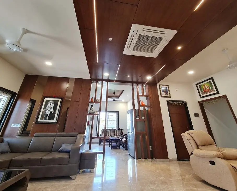 Living room with a timber-panelled ceiling, leather sofas and a recliner